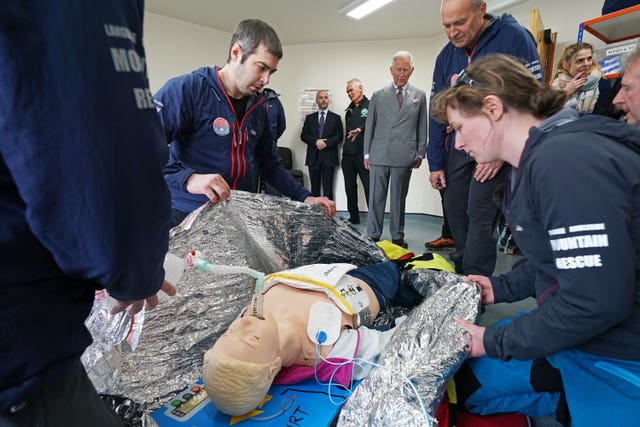 Charles watches volunteers taking part in a training exercise