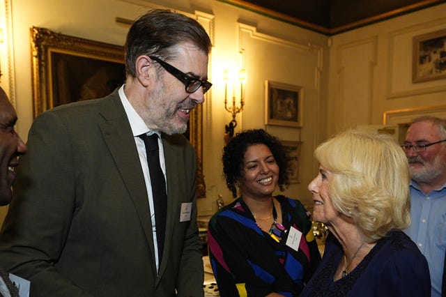 The Queen speaking with author and TV presenter Richard Osman at a BookTrust reception