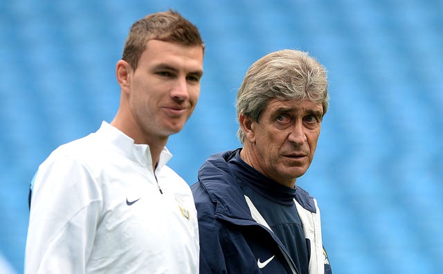 Former Manchester City manager Manuel Pellegrini talks with Edin Dzeko 