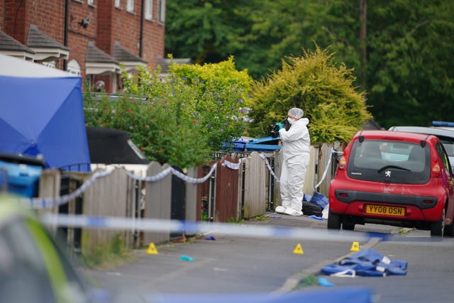 Forensic officer with a camera at the scene 