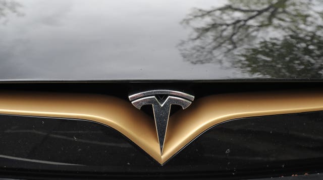 A Tesla logo on the front of a Model S car