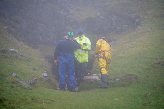 Rescuers at the entrance of the Ogof Ffynnon Ddu cave system near Penwyllt, Powys in the Brecon Beacons, Wales
