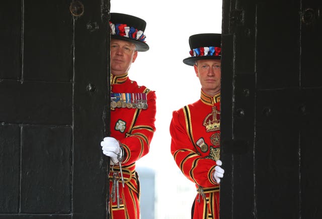 Yeoman Warder Darren Hardy and Yeoman Serjeant Clive Towell open the West Door at the Tower of London