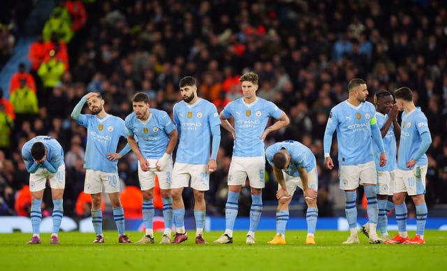 Manchester City players look on dejected during last season's penalty shoot out defeat to Real