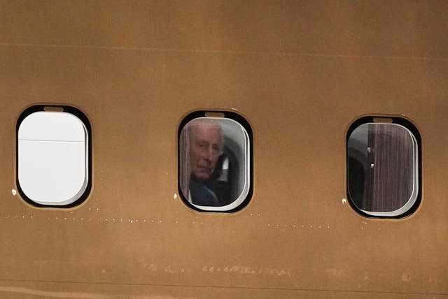 The King peers out of his plane window