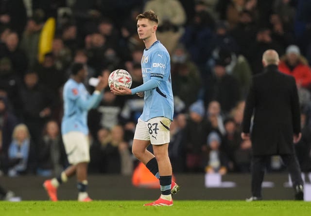 James McAtee carries the matchball after scoring a hat-trick for Manchester City against Salford