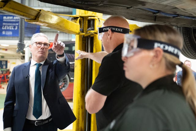 Labour Party leader Sir Keir Starmer with workers during a visit to Grimsby Institute