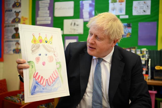 Boris Johnson with the portrait he painted of the Queen during a visit to Field End Infant school, in South Ruislip 