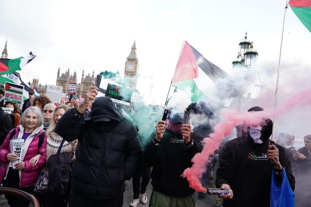 Protesters letting off green and red flares