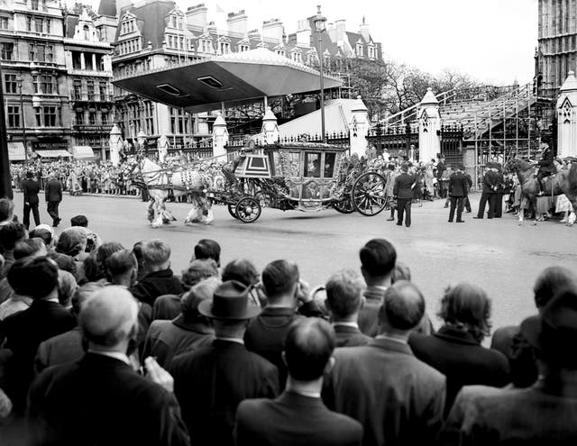 Crowds watching the Speaker’s coach leave the Houses of Parliament for Westminster Abbey, for a Coronation rehearsal 