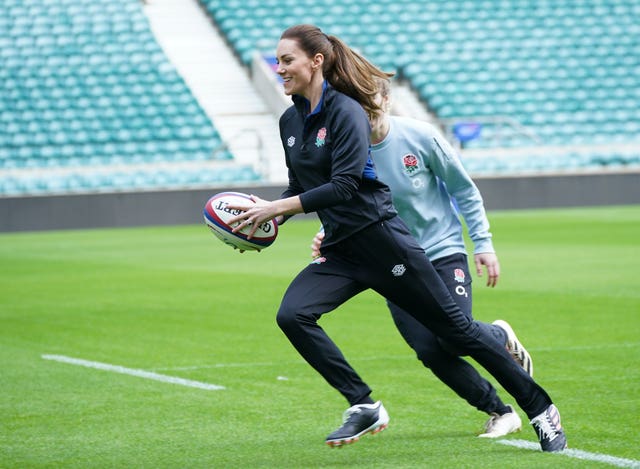 Kate runs with a rugby ball during a training session on a visit to Twickenham Stadium to meet England players in 2022