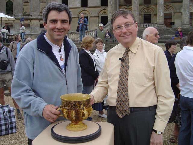 Antique expert John Sandon, right, with the 17th century slipware cup he valued on Antiques Roadshow