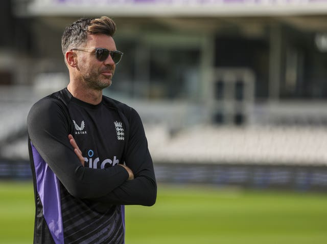 James Anderson, with his arms folded, looks on at an England training session