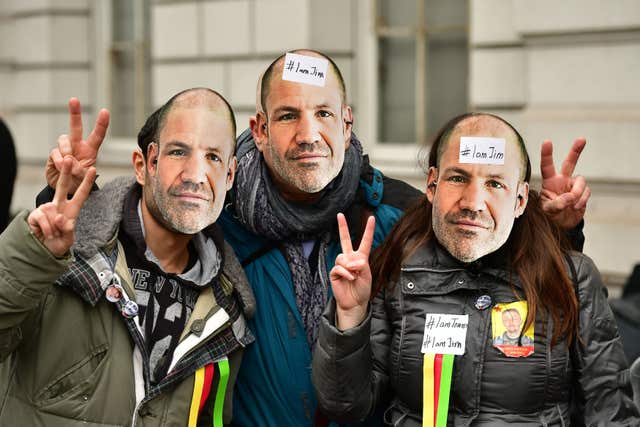 Supporters of James Matthews wear masks with his face on outside Westminster Magistrates’ Court (Dominic Lipinski/PA)