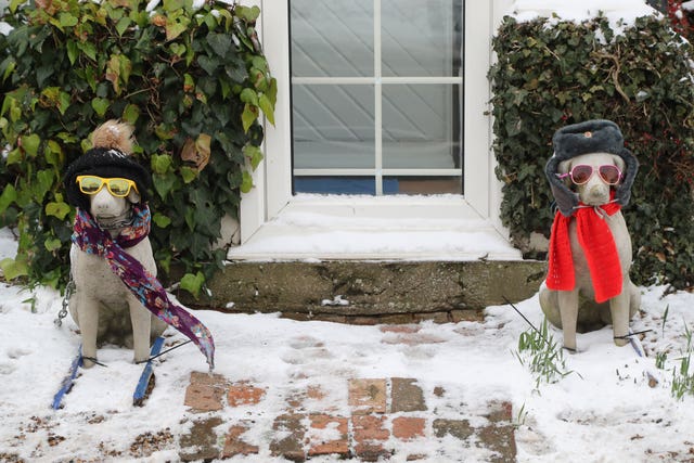 Ornamental dogs dressed for the snow in Minster, Kent