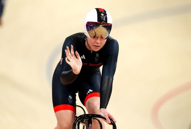 Emma Finucane waves while on the track. 