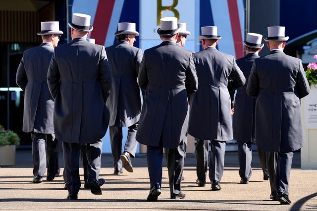 Members of Royal Ascot staff in top hats and tailcoats from behind