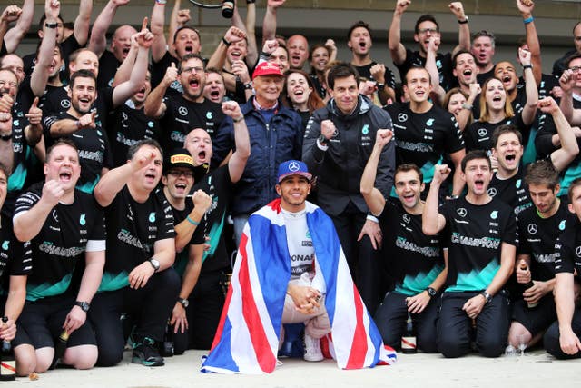 Hamilton celebrates winning the 2015 Formula One world championship alongside Lauda, Toto Wolff and the rest of the Mercedes team after the United States Grand Prix at the Circuit of The Americas in Austin, Texas 