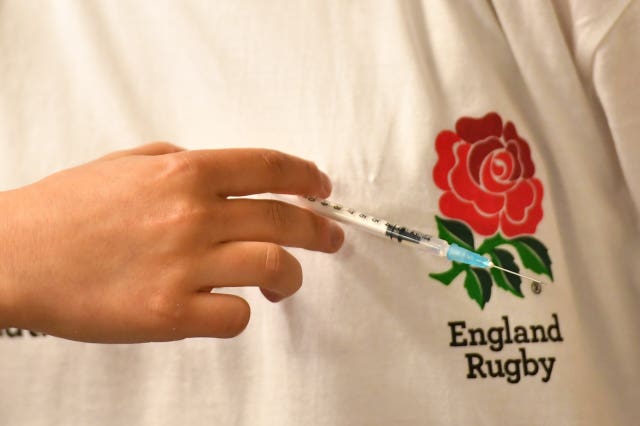 A person prepares to give a member of the public a coronavirus vaccination at Twickenham rugby stadium, south-west London (Dominic Lipinski/PA)