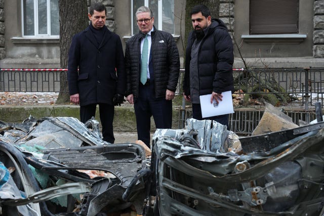 Prime Minister Sir Keir Starmer inspects a damaged vehicle during his visit to Ukraine