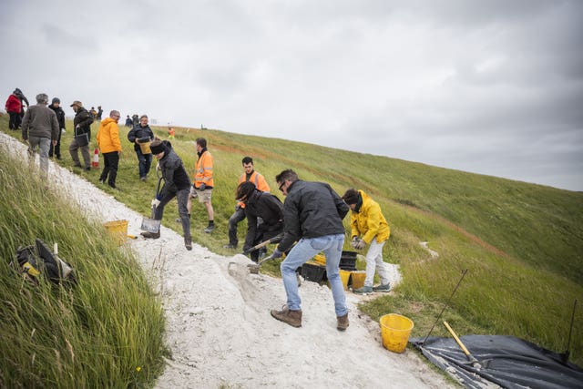 People 'rechalking' the White Horse