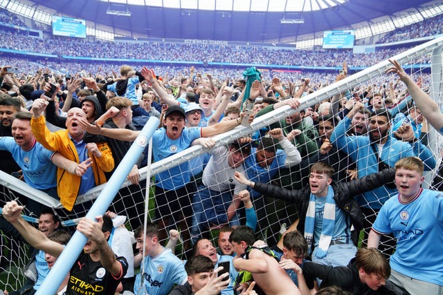 Manchester City fans invade the pitch and break the goal