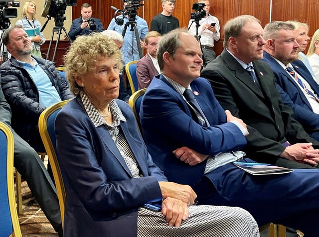 Baroness Kate Hoey sits on a chair at the end of a row with several men