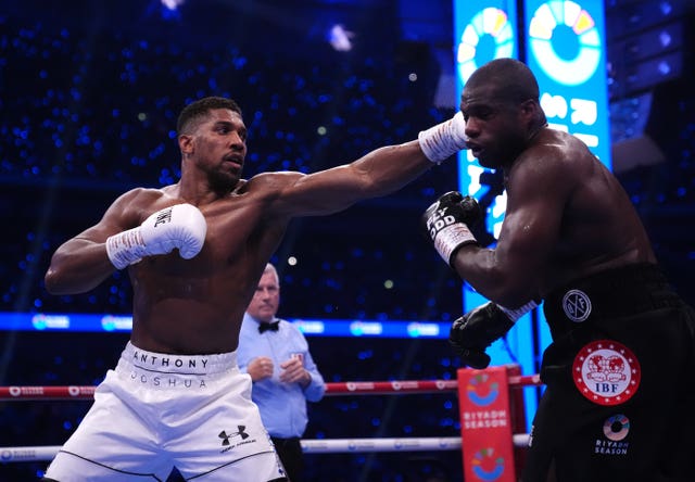 Anthony Joshua lands a blow on Daniel Dubois in their IBF Heavyweight Title bout.