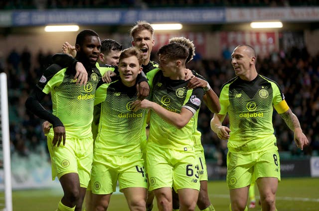Ajer (back) joins in with the rest of his team-mates as they celebrate James Forrest's opener at Easter Road