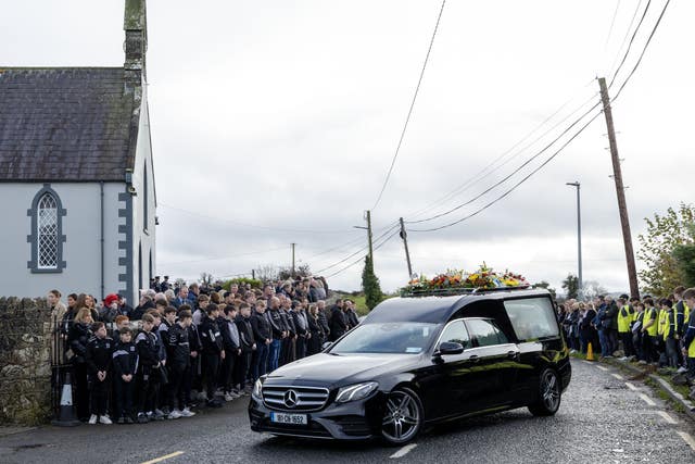 Mourners line the route as the hearse carrying the coffin of Shay Duffy arrives for his funeral at St Patrick’s Church in Rockchapel, Co Monaghan