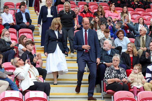 William walks through the stadium stand as members of the public sit in the seats on a visit to Parc y Scarlets, the home of the Scarlets rugby union team