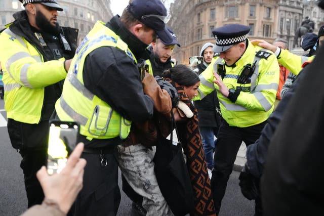 Police detaining a protester