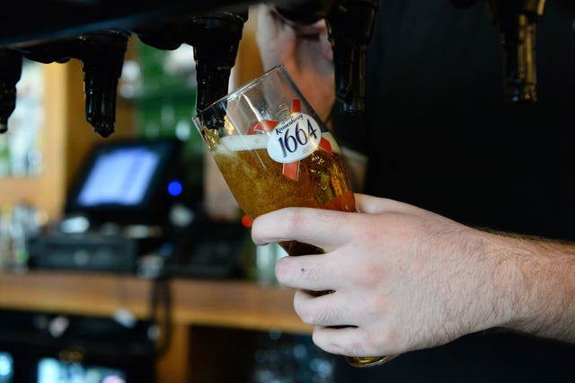 A bar tender pouring a Kronenbourg beer in a pub in Fulham, London (Kirsty O'Connor/PA)