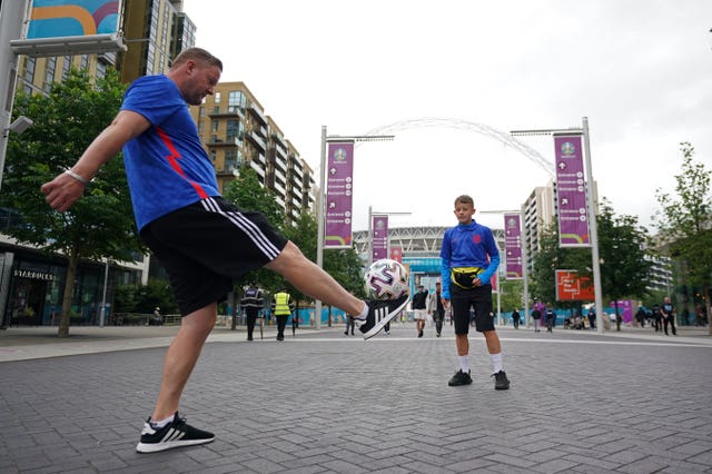 Fans play football outside Wembley Stadium several hours before the semi-final match with Denmark