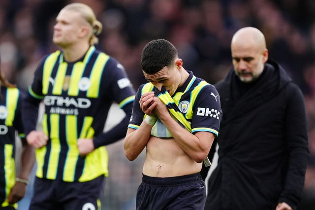 Phil Foden wipes his face with his shirt after Manchester City's defeat at Aston Villa