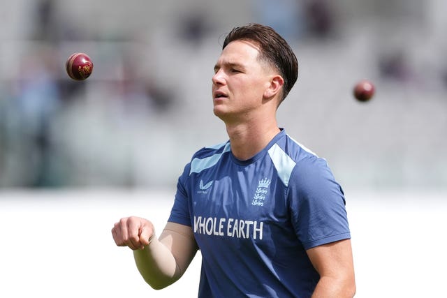 Sonny Baker tosses a ball in England training gear.