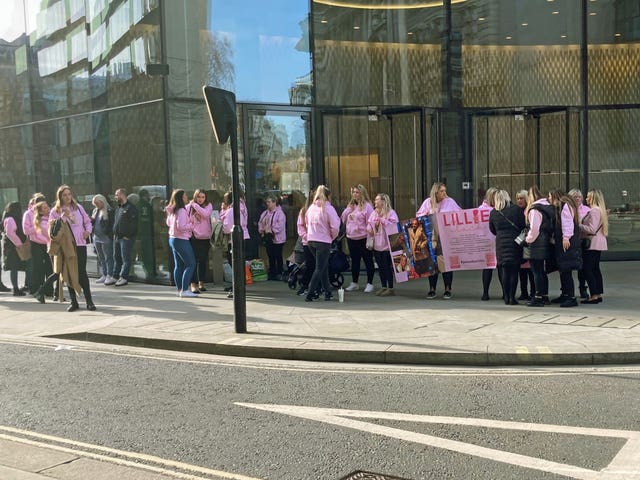 Friends and family of Lillie Clack dressed in pink during a protest outside the Old Bailey in central London
