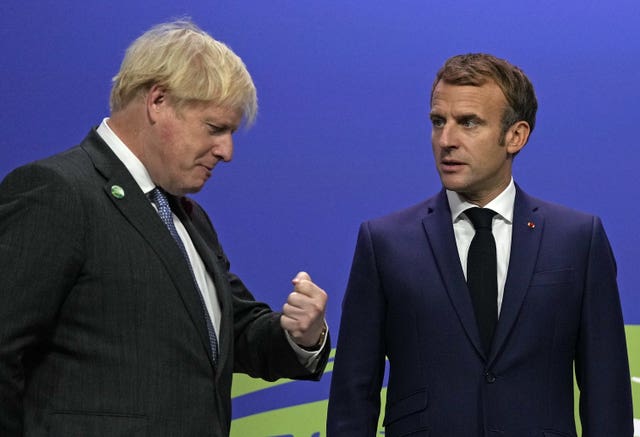 Boris Johnson (left) greets French President Emmanuel Macron