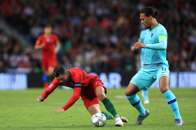 Portugal captain Cristiano Ronaldo battles with Holland counterpart Virgil Van Dijk in the Nations League final