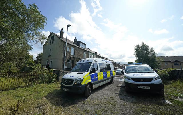 Police outside a house in Carlby Grove