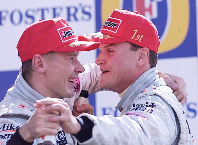McLaren Mercedes driver David Coulthard, right, celebrates on the podium with team-mate Mika Hakkinen after victory in 2000. It was a second successive Silverstone win for the Scot