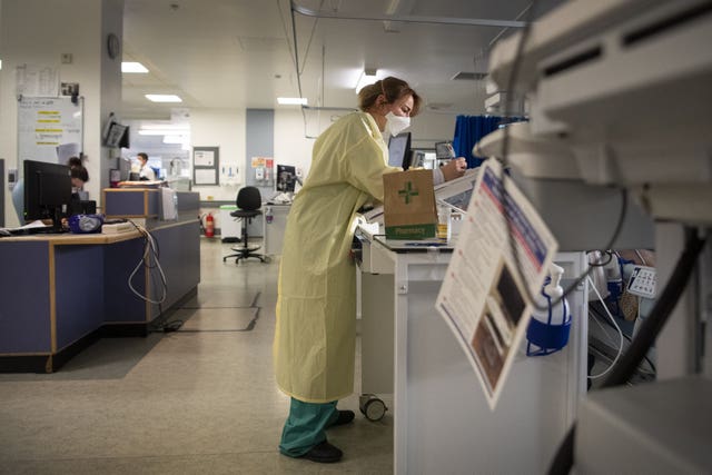 A nurse writes-up notes on a patient