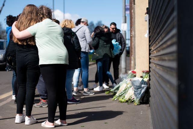 Flowers and tributes are left at the scene on High Street, Brownhills, near Walsall in the West Midlands