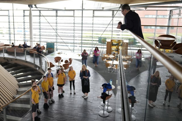 Prime Minister Sir Keir Starmer and First Minister of Wales Vaughan Gething (obscured) listen to a choir at the Senedd, in Cardiff, Wales, during his tour of the UK following Labour’s victory in the 2024 General Election