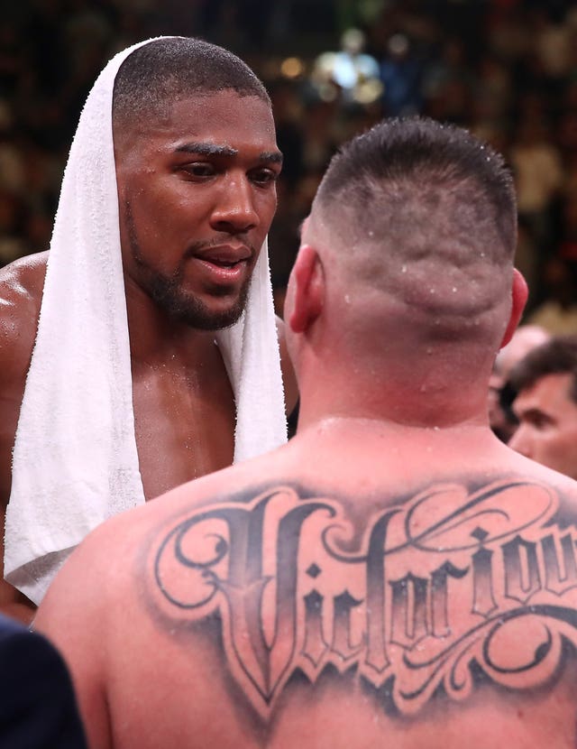 Andy Ruiz, with a tattoo reading 'victorious', talks with Anthony Joshua, left, after the fight