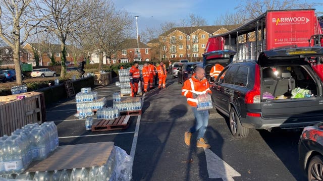 Customers line up for their water allocation