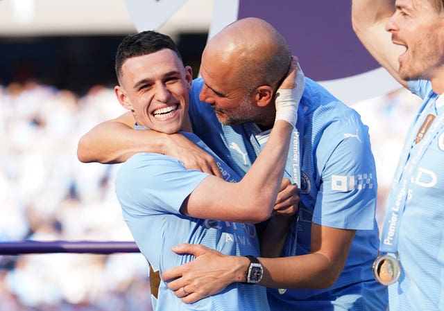 Pep Guardiola, right, celebrates with Phil Foden