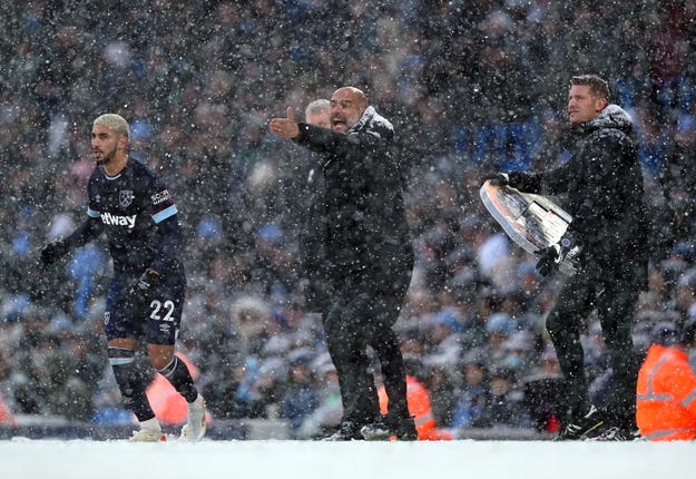 Manchester City manager Pep Guardiola, centre, shouts instructions