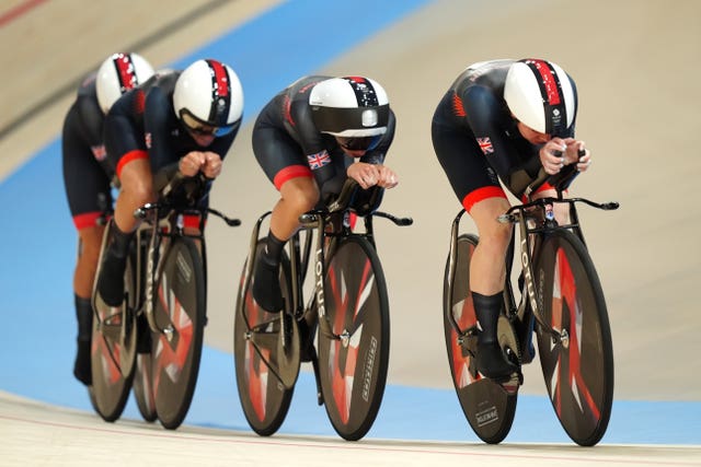 Four women crouched over handlebars during a cycle race