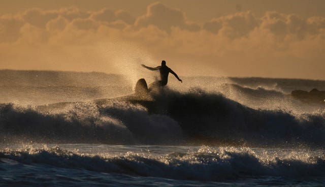 A surfer at Tynemouth Longsands beach on the North East coast on September 11 2024 